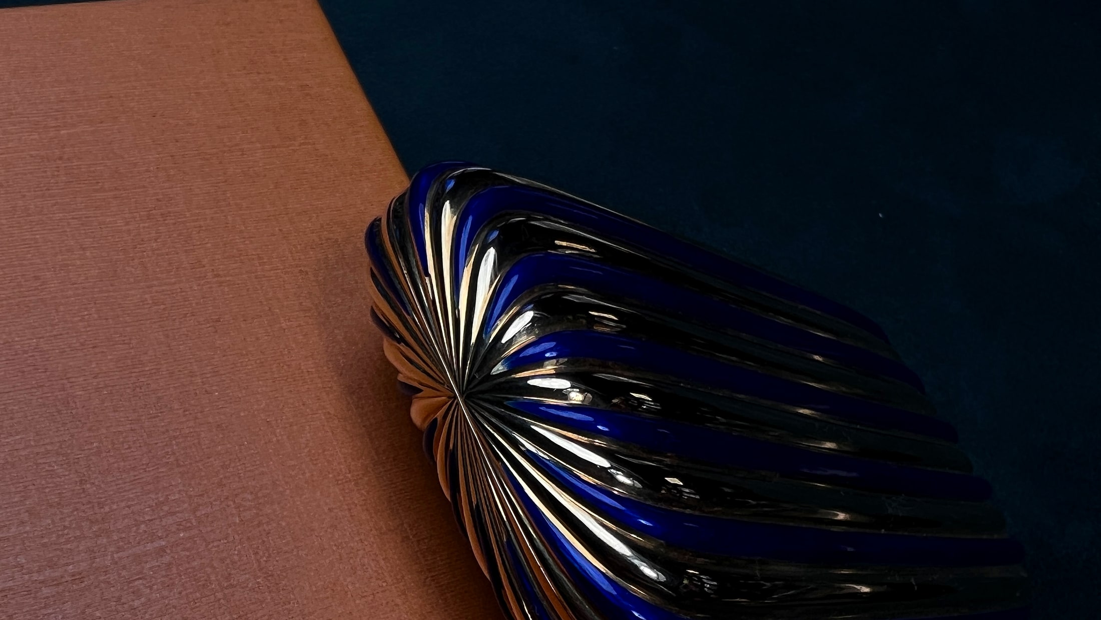 Blue shell vintage lighter on a quiet salon surface