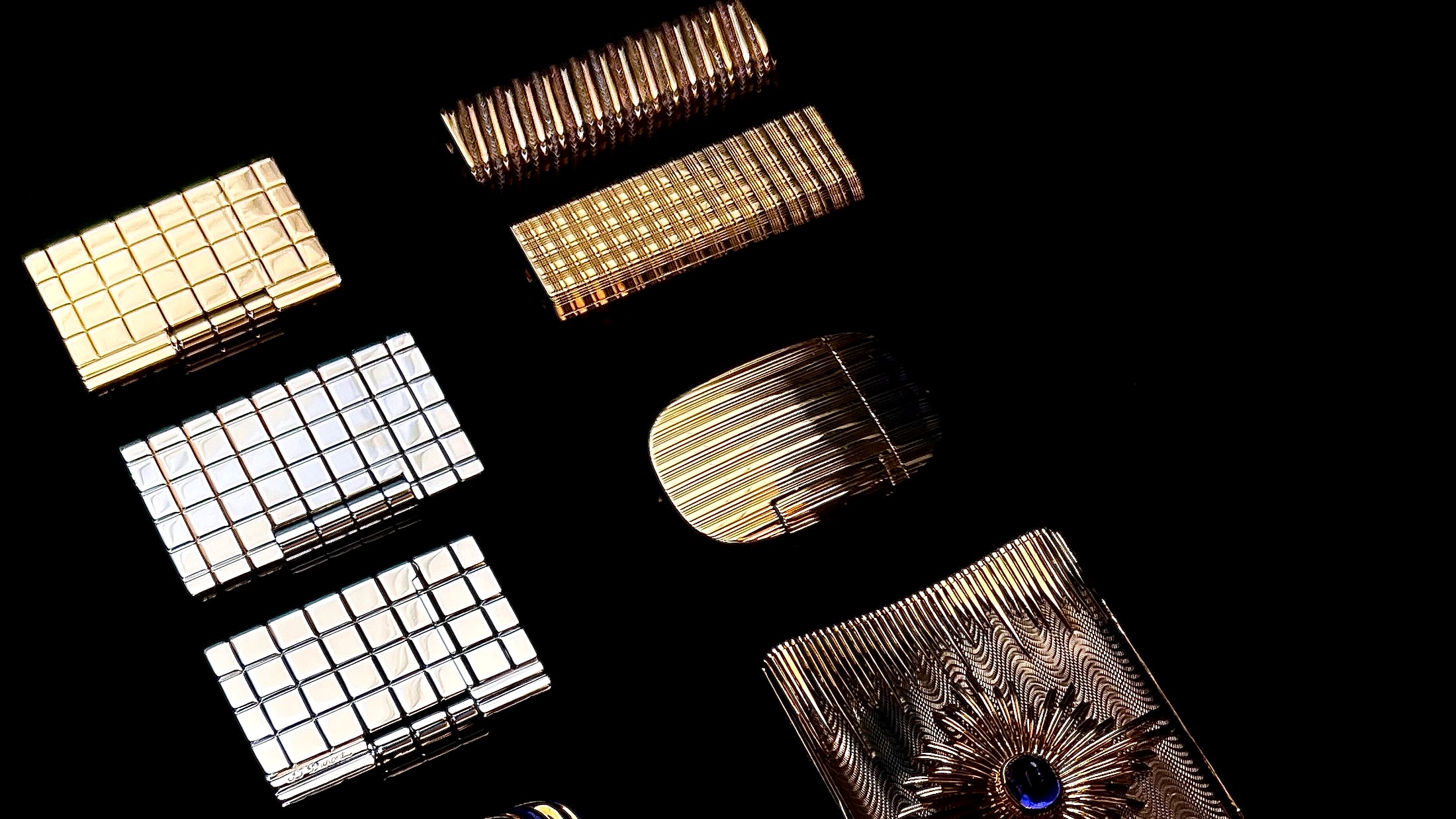 Vintage lighters arranged on dark green velvet